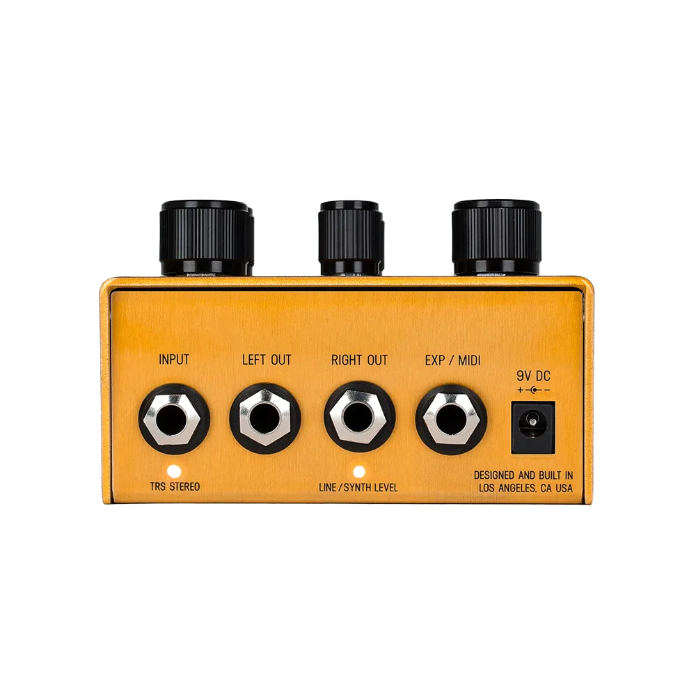 A back view of the gold Meris Enzo guitar pedal, on the back of the pedal are various input and output ports as well as a 9V DC power port