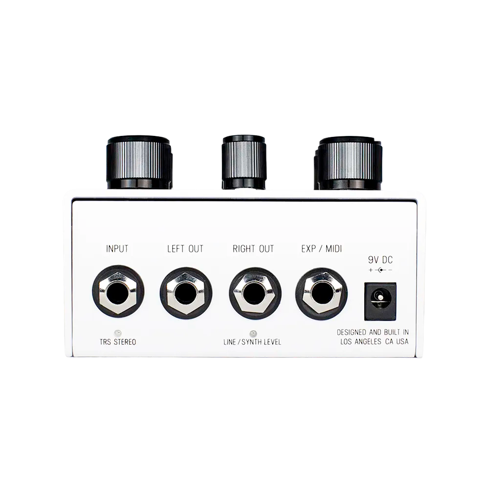 A back view of the white Meris Polymoon guitar pedal, the image shows the input and output ports on the Polymoon as well as the 9V DV power port